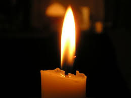 Photo of candle illuminating darkness
